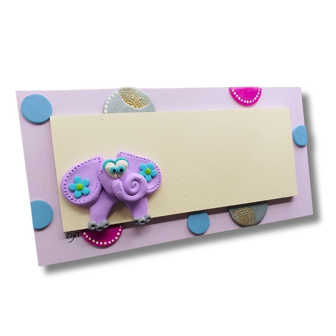 שלט פיל, סגול, עיצוב חדר בנות, שלט עם שם, שלט עץ, אקססוריז לבית, עבודת יד, חימר פולימרי, גיתוש עיצובים. שלט פיל, סגול, עיצוב חדר בנות, שלט עם שם, שלט עץ, אקססוריז לבית, עבודת יד, חימר פולימרי, גיתוש עיצובים.