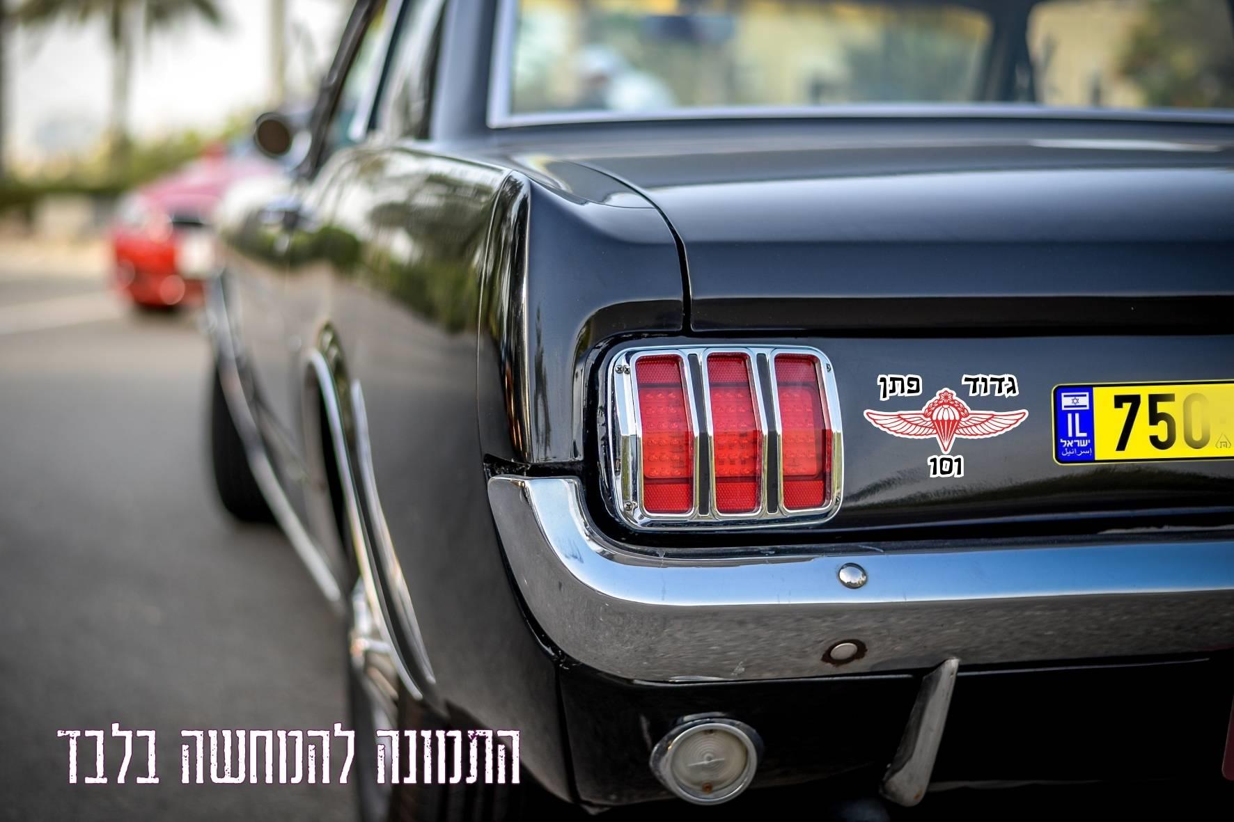 רכב שחור עם מדבקת חטיבת הצנחנים – גדוד פתן 101, על גבי תא המטען – המחשה לשימוש בפועל.